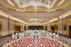 a ballroom with tables and chairs in a room with a chandelier at Renaissance Shanghai Hongqiao in Shanghai +73 photos
