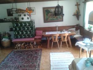 a living room with a table and a dining room at Alpenhaus Birkhahn in Ramsau am Dachstein