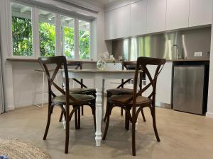 a kitchen with a table and four chairs at Somerset Palms Studio Apartment in Horseshoe Bay