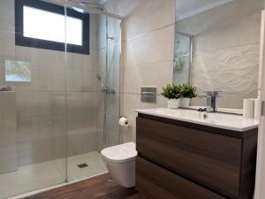 a bathroom with a toilet and a glass shower at Golden Flower in Tacoronte +19 photos