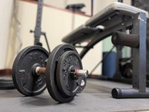 a gym with two dumbbells on the floor at Golden Flower in Tacoronte