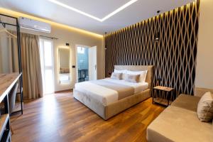 a hotel room with a bed and a couch at Bliss Boutique Hotel in Durrës +113 photos