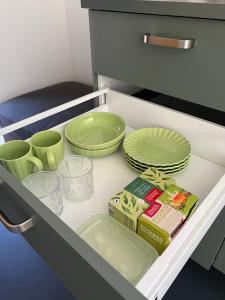 a drawer with plates and dishes in a kitchen at Het Hunebedje in Vries +22 photos
