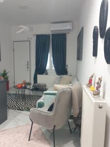 a bedroom with a bed and a chair in it at Mimis House in Tsotílion