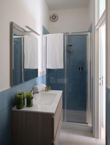 a bathroom with a sink and a shower at Villa Coccodrilla in Toscolano Maderno +19 photos