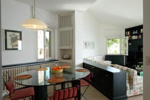 a living room with a table and a couch at Villa Coccodrilla in Toscolano Maderno