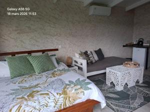 a bedroom with a bed and a couch at Fare Oasis in Temae