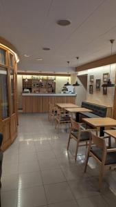 a restaurant with tables and chairs and a bar at Hotel Fonda Agusti in Esterri d'Àneu