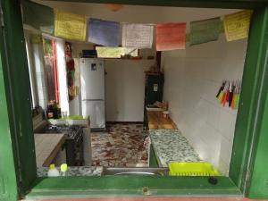 a kitchen with a sink and a stove and a refrigerator at Oasis Palmarin in Palmarin