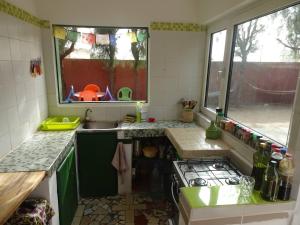 a small kitchen with a sink and a stove at Oasis Palmarin in Palmarin