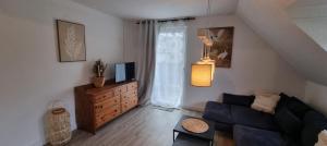a living room with a couch and a tv at Moselhof in Burg