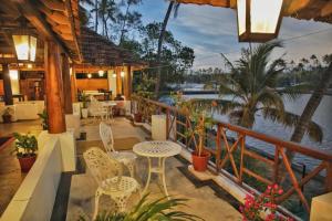 a patio with tables and chairs and a view of the water at halo in Ahangama