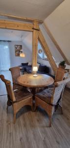 a dining room table with wicker chairs in a room at Moselhof in Burg