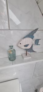 a shelf with a figurine of a fish on it at Moselhof in Burg +10 photos