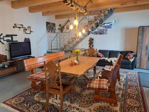 a living room with a wooden table and chairs at Pension Garage in Kutná Hora