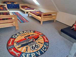 a bedroom with three beds and a rug on the floor at Pension Garage in Kutná Hora