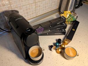 a coffee maker on a counter with a cup of coffee at The Sunny Side Apartment in Florina