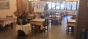 a dining room with tables and chairs in a restaurant at Hotel Fonda Agusti in Esterri d'Àneu +24 photos