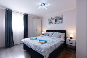 a bedroom with a large bed with blue pillows at Emma in Krasica