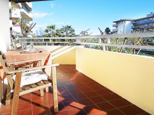 a balcony with a table and chair on a roof at Apartamento Florencia in Salou