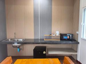a kitchen with a counter top with a sink and a sink at Wangpocamping วังโพแค้มป์ปิ้ง in Ban Wang Pho