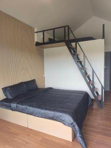 a bedroom with a bunk bed with a staircase at Wangpocamping วังโพแค้มป์ปิ้ง in Ban Wang Pho