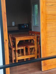 a wooden table and chairs in a kitchen at Wangpocamping วังโพแค้มป์ปิ้ง in Ban Wang Pho +36 photos