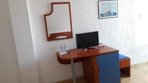a desk with a computer monitor and a mirror at Villa Amadeus in Nesebar