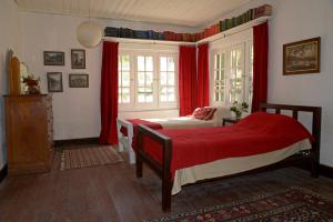 a bedroom with two beds and red curtains at Casona 1905 in San Rafael +29 photos