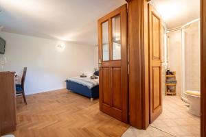 a bedroom with a bed and a door leading to a bathroom at Pri Dopivcu in Log pod Mangartom