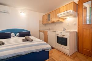 a small kitchen with a bed in a room at Pri Dopivcu in Log pod Mangartom +51 photos