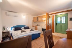 a small bedroom with a bed and a kitchen at Pri Dopivcu in Log pod Mangartom