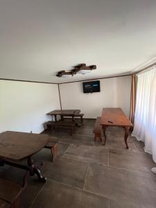 a room with two tables and a tv on the wall at У Блищака in Pilipets