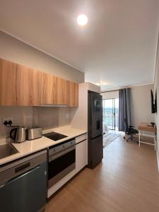 a kitchen with stainless steel appliances and wooden cabinets at 95 Yang Suite A in Johannesburg