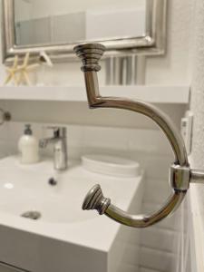 a bathroom sink with a faucet and a mirror at Altstadtrefugium "Backsteenhuus" und ,,Li ebertee" in Leer in Leer +35 photos