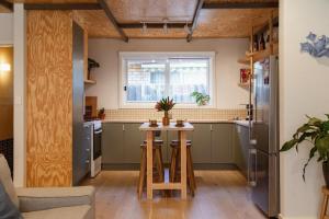 a kitchen with a small table and a refrigerator at Kodok House in Melbourne