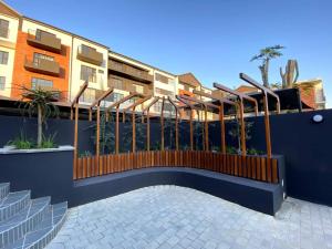 a fence in front of a building with a staircase at 95 Yang Suite A in Johannesburg