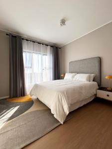 a bedroom with a large bed and a large window at 95 Yang Suite A in Johannesburg +36 photos