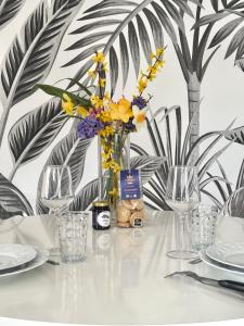 a table with a vase of flowers on it at T2 Cosy in Mende