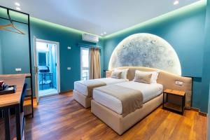 a bedroom with a bed and a desk at Bliss Boutique Hotel in Durrës