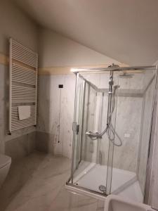 a glass shower in a bathroom with a toilet at Hotel HDomus in Nogarole Rocca