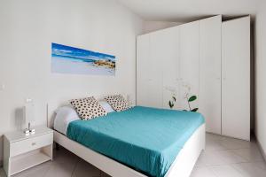 a white bedroom with a bed with a blue blanket at Sunset Apartment 2Bedr Sunset View Parking in Bosa +16 photos