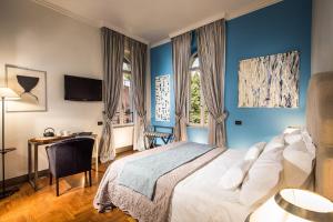 Postel nebo postele na pokoji v ubytování Hotel Villa Linneo