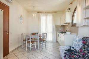 a kitchen and dining room with a table and chairs at Villetta Tina in Vada