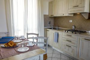 a kitchen with a table with a plate of food on it at Villetta Tina in Vada