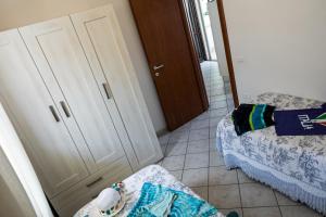 a room with a bedroom with a bed and a closet at Villetta Tina in Vada
