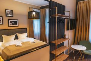 a bedroom with a bed and a book shelf at Cityloft Erfurt in Erfurt