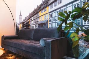 a couch sitting in a room next to a building at Cityloft Erfurt in Erfurt