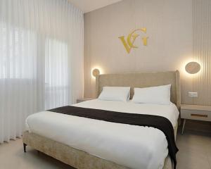 a bedroom with a large bed with white sheets at וילה ג'נסיס - וילה מהממת למשפחות עם בריכה פרטית מחוממת ליד הכנרת in Migdal