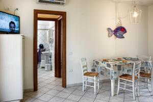 a dining room with a table and a butterfly on the wall at Villetta Tina in Vada